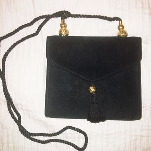 Black vintage shoulder bag with tassel snap close